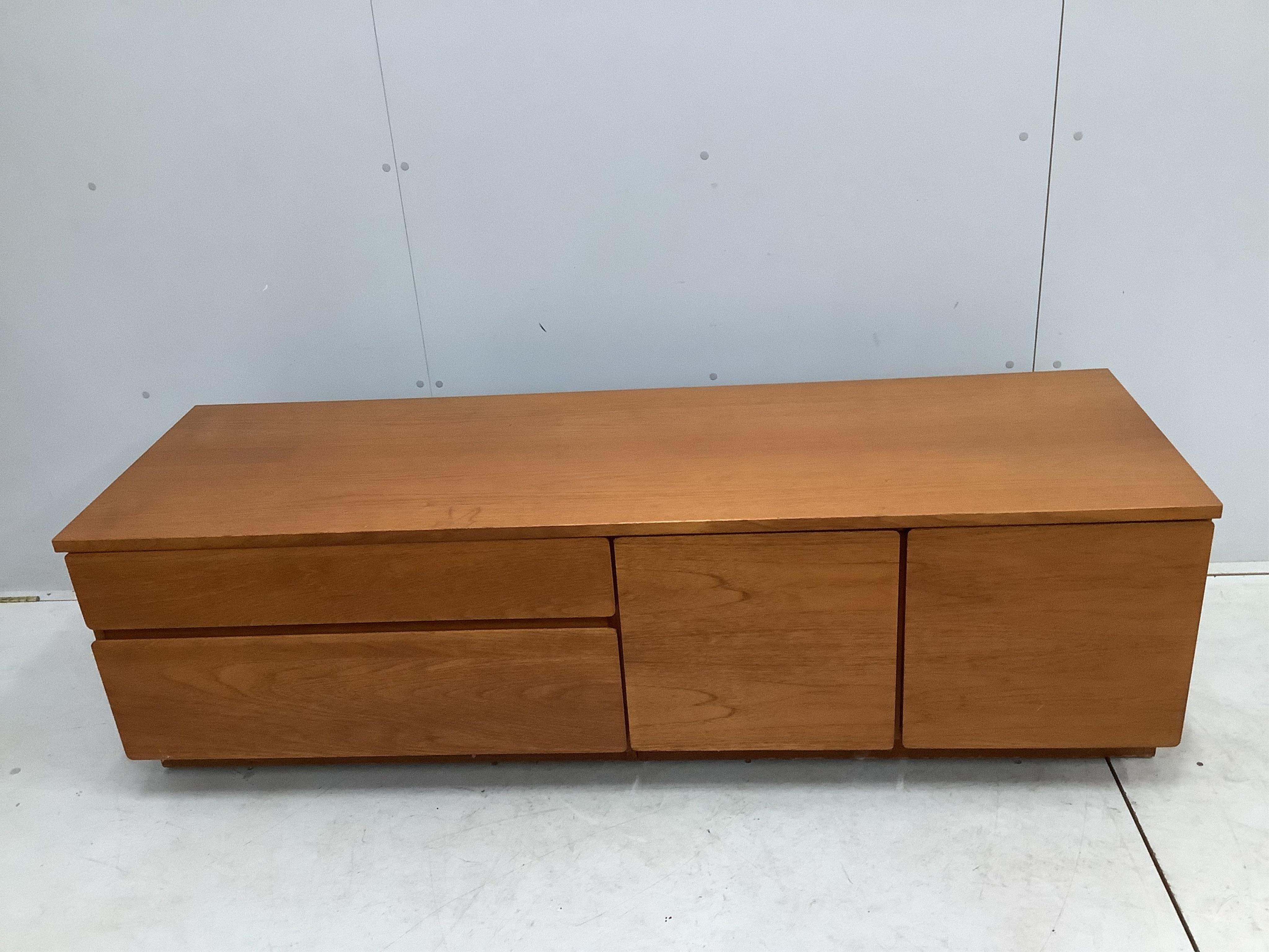 A mid century McIntosh teak extending dining table, width 150cm, depth 82cm, height 74cm together with four chairs, and a low sideboard. Condition - fair to good